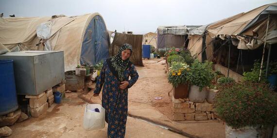 Matra who was displaced from her village has planted flowers in her temporary home i