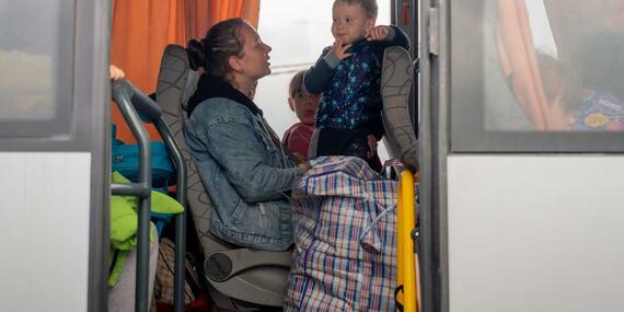Families on a bus wait to depart from Zaporizhzhia