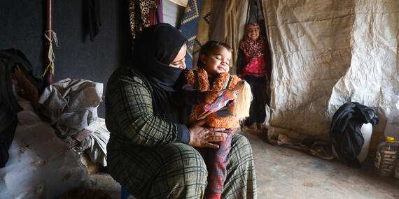 A mother with her child in a camp for displaced people