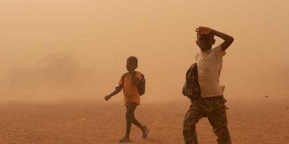 Boys walk through heat and sand storms in Burkina Faso