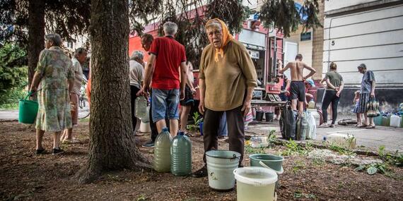 A woman collecting water from a water truck in Lysychansk, Luhansk region. June 2022.