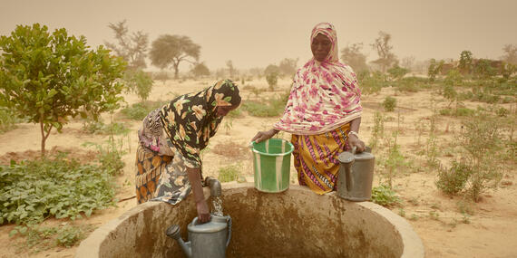Women collecting water from a well in Niger