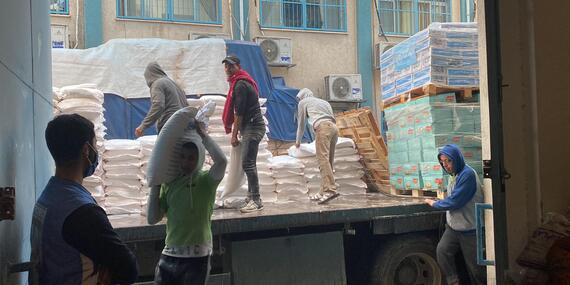 Men unload boxes from a truck
