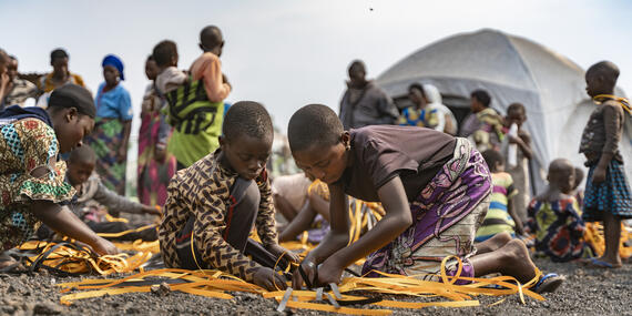 Residents of the Bulengo site for internally displaced people in North Kivu, DRC, learn how to weave baskets.