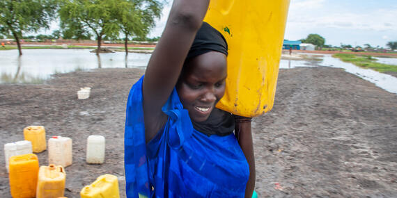 A returnee woman carries a jerrycan from a water point at a transit centre in Rubkona County, in South Sudan's Unity State.