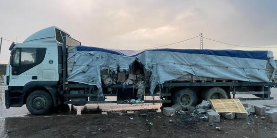 A lorry with its middle portion gutted with destroyed packages spilling out.