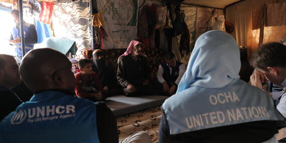 A UN delegation including OCHA speak to households who received WFP food vouchers and IOM winter kits with the support of the NGO, IYD at Ali Bin Abi Taleb camp in Sarmada town in Idleb, Syria