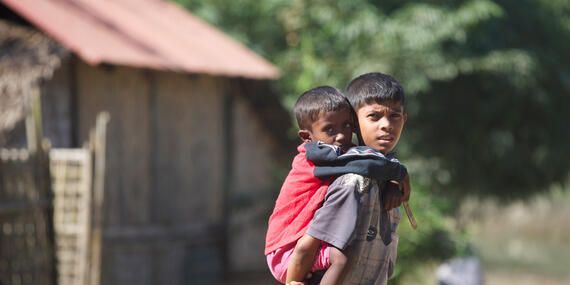 A boy carries a little boy on his back in Rakhine State, Myanmar.
