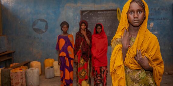 Kori Woreda, Afar Region. Four girls, students in the 5th grade, stand in their classroom. 