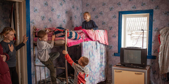Olha and her children are kept warm in a shelter in a village in the Chernihiv Region, north Ukraine, as part of a winter campaign by aid workers.