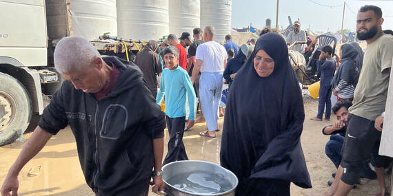 Displaced people in Al Mawasi getting water provided by tankers, 17 May 2024.