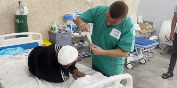 A nurse treating an injured person in a newly established trauma stabilization point in Rafah.