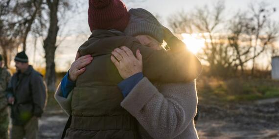 A woman in Zavody, a town in Kharkiv, Ukraine, hugs an aid worker for the support she received.