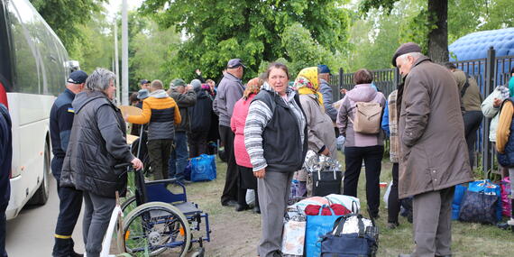 People who have been evacuated from front-line and border communities of the Kharkiv Region register for multi-purpose cash assistance at the Kharkiv City transit centre.
