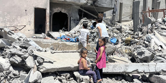 Children play by a damaged building following the latest round of fighting between Israel and Palestinian militants