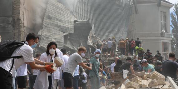 People make human chain to clear debris after attack by the Russian Federation Armed Forces on Ohmatdyt Children's Hospital in Kyiv, Ukraine