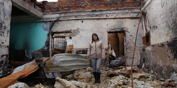 Olesia, a local teacher in the Kharkiv Region, stands in her destroyed classroom.