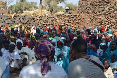 Aid workers listen to Internally displaced people in Darfur. 