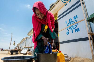 Haj. Aishe Mohammed, 55 does her laundry in front of her shelter in Muna camp, Maiduguri.