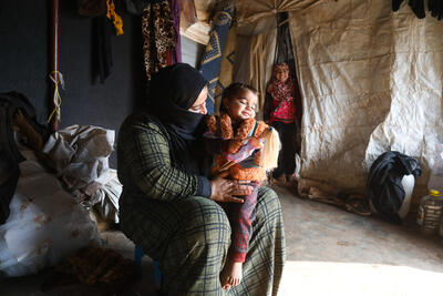 A mother with her child in a camp for displaced people