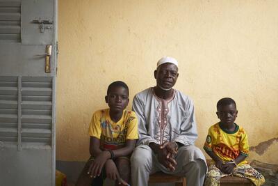 Dahani Adama with his children in a house where they found a shelter in Fada,