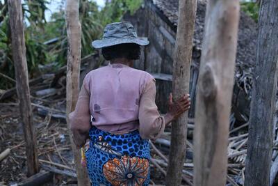 A woman looks at what is left of her house after Cyclone Freddy hit Mananjary.