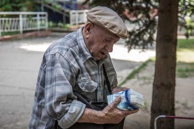 Oleksandr, 84, receives food support through humanitarian organizations on the ground in Kramatorsk, Donetsk region. July 2022