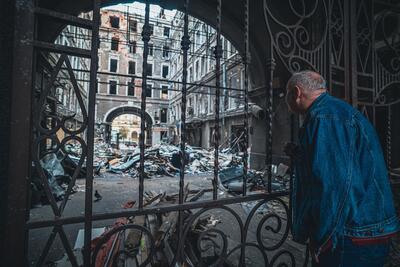Elderly man looks upon the devastation of war in Ukraine