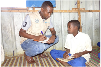 READO official registering Abdullah for his school at the IDP site in Baidoa region, Somalia. 