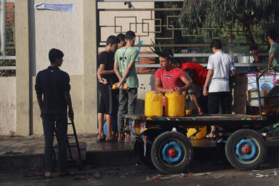 People collect water in Khan Younis city, southern Gaza Strip, amid escalating hostilities. Most of the Gaza Strip’s water systems are heavily impacted and/or non-operational due to the security situation, a lack of fuel, and damage to production, treatment and distribution infrastructure.