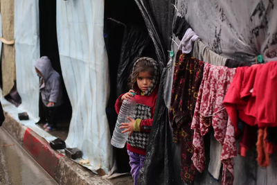 Displaced children outside their improvised shelters in Gaza.
