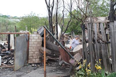 Ukraine Kharkiv residents clear the debris after their homes were destroyed in an overnight attack.