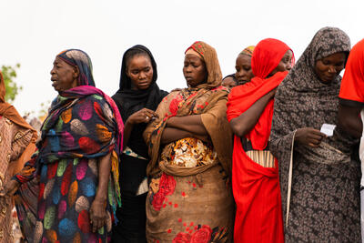 Women wait for distribution of aid in Wad Madani, Sudan