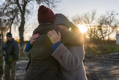 A woman in Zavody, a town in Kharkiv, Ukraine, hugs an aid worker for the support she received.