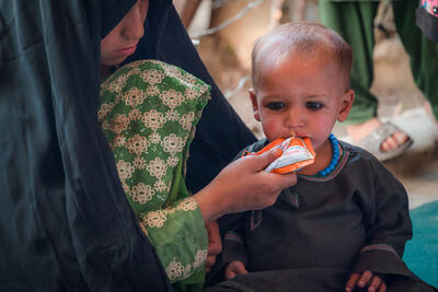 A child receives ready-to-use therapeutic food to treat malnutrition at a mobile clinic in Afghanistan's Kandahar province.