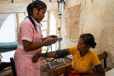 A nurse takes the blood pressure of a woman at a mobile clinic in a village in Madagascar’s Amboasary region. Photo: OCHA/ Viviane Rakotoarivony .