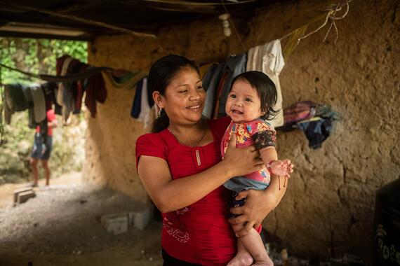 A woman in Guatemala holds her child