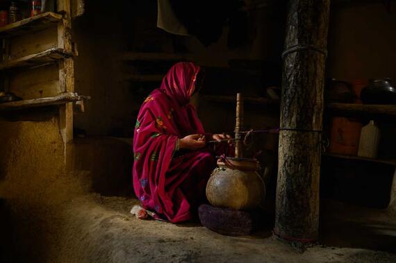 An Afghan woman cooking in her home