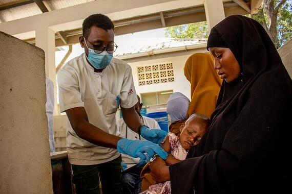 A health worker attending to a mother and child 