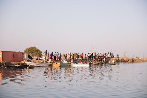 Children stand on one of the dykes surrounding the Bentiu camp