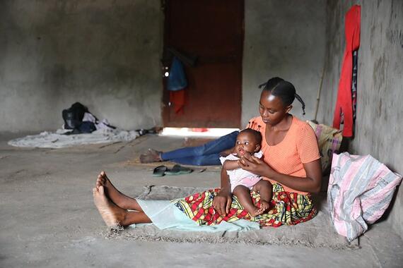 A displaced mother, holds her daughter.