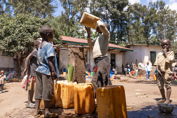 Young boys fetch water in jerrycans. DRC