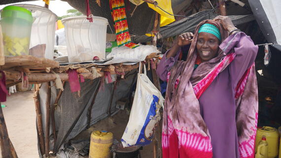 Amina tends to her grocery stall at the Water Ground displacement site, Tana River County, after being displaced by floods in late 2023