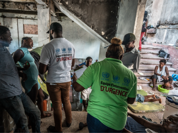 Staff from local NGO partner UCCEDH assess needs at a displacement camp at the Rex Medina theatre in downtown Port-au-Prince, Haiti. 