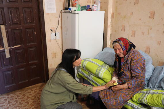 Iryna, an aid worker from the Relief Coordination Centre, comforts an evacuee now living in one of the city’s collective sites for displaced people in Ukraine's Kharkiv Region.