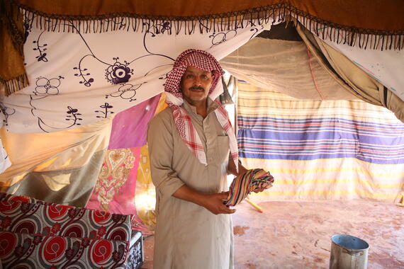 A man with a towel inside a tent in Al-Hamra camp in Syria's Idleb governorate.