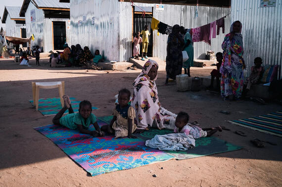 A mother and her children rest in the shade at Renk Transit Centre.