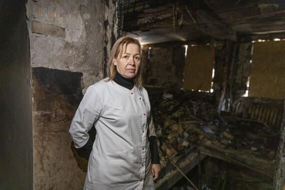 Iryna stands inside a heavily damaged facility in Dnipro, Ukraine