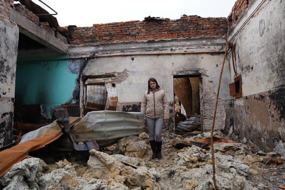 Olesia, a local teacher in the Kharkiv Region, stands in her destroyed classroom.