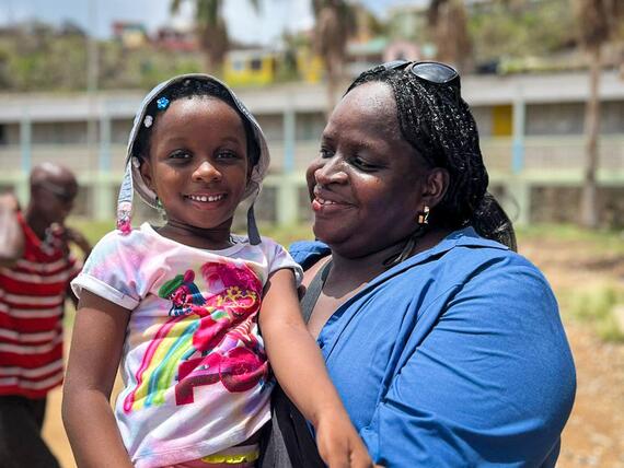 A mother and daughter smiling